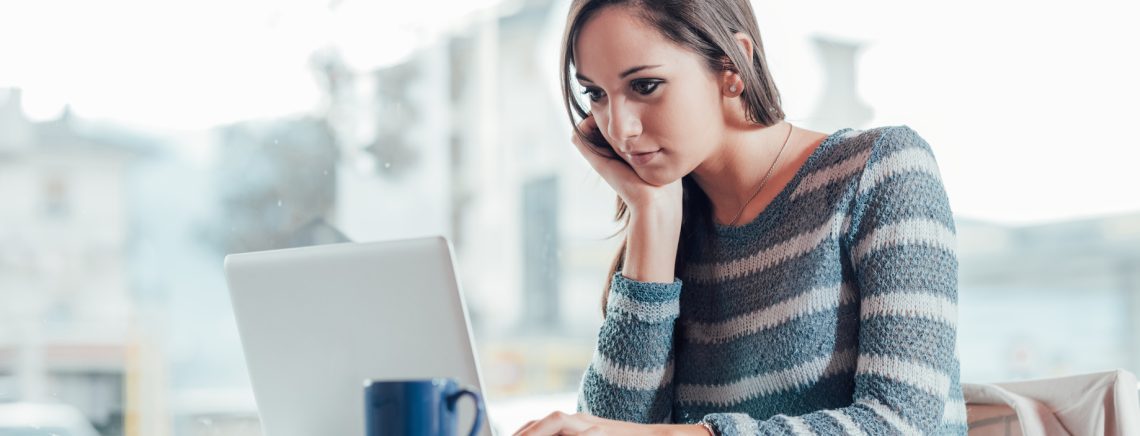 Busy young woman working with her laptop on a desk